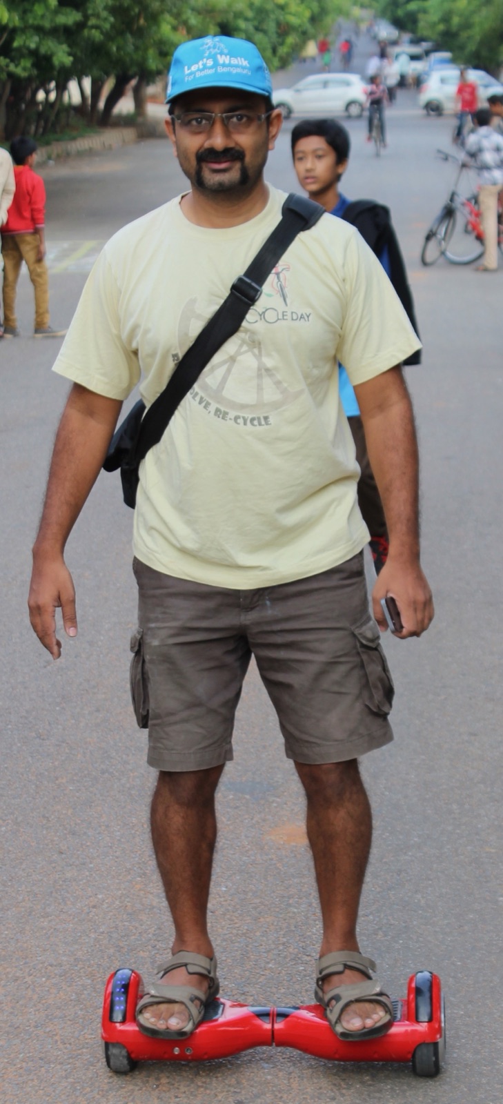 Sathya Sankaran on a hoverboard wearing a Cycle Day t-shirt and Let's Walk for Better Bengaluru cap